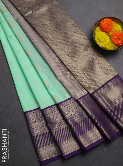 Semi kanchipuram silk saree mild teal green and purple with allover zari woven buttas and long zari woven korvai border