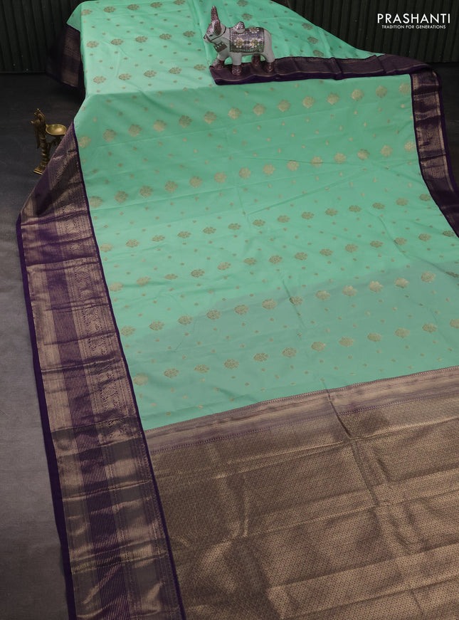 Semi kanchipuram silk saree mild teal green and purple with allover zari woven buttas and long zari woven korvai border