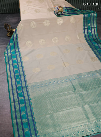 Semi kanchipuram silk saree beige and teal green with zari woven buttas and long zari woven korvai border