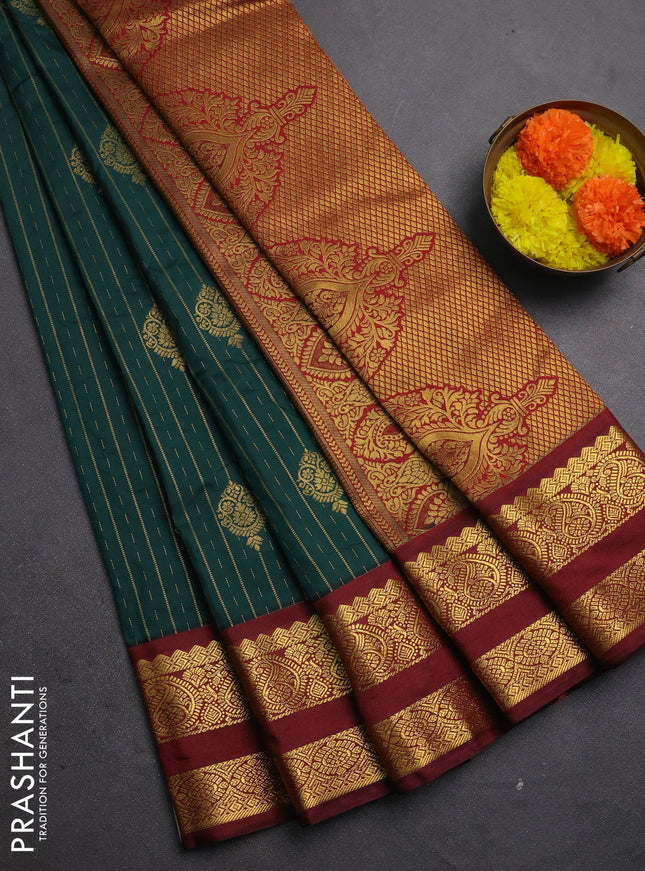 Semi kanchipuram silk saree peacock green and deep maroon with allover zari stripes & buttas and rettapet zari woven korvai border