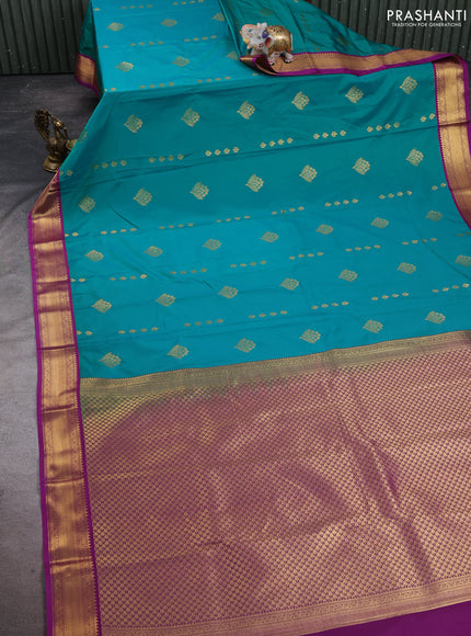 Semi kanchipuram silk saree teal green and purple with allover zari woven buttas and zari woven korvai border