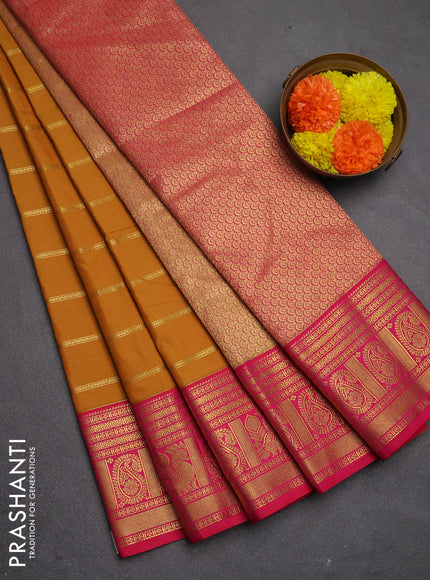 Semi kanchipuram silk saree dark mustard and pink with allover zari weaves and zari woven korvai border