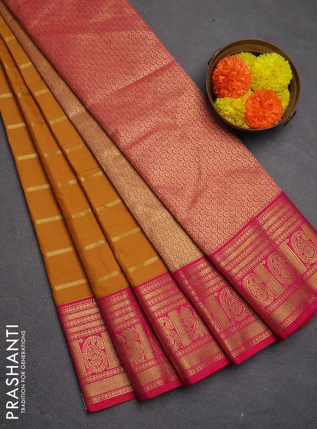 Semi kanchipuram silk saree dark mustard and pink with allover zari weaves and zari woven korvai border