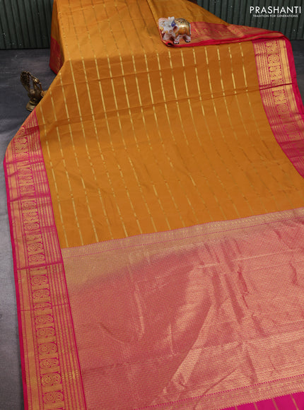 Semi kanchipuram silk saree dark mustard and pink with allover zari weaves and zari woven korvai border