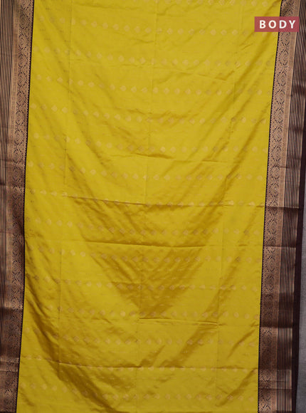 Semi soft silk saree yellow and coffee brown with allover zari woven buttas and zari woven border