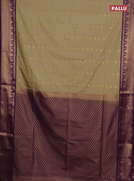 Semi soft silk saree elachi green and purple with allover zari woven buttas and zari woven border