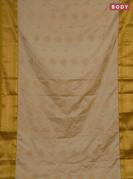 Semi soft silk saree beige and mustard yellow with allover zari woven buttas and zari woven border