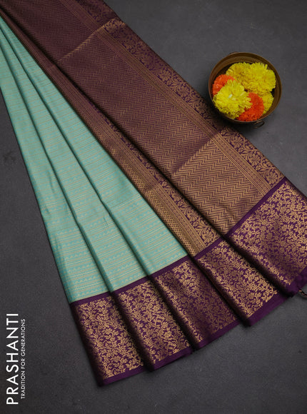 Semi soft silk saree teal green and purple with allover zari brocade weaves and zari woven border