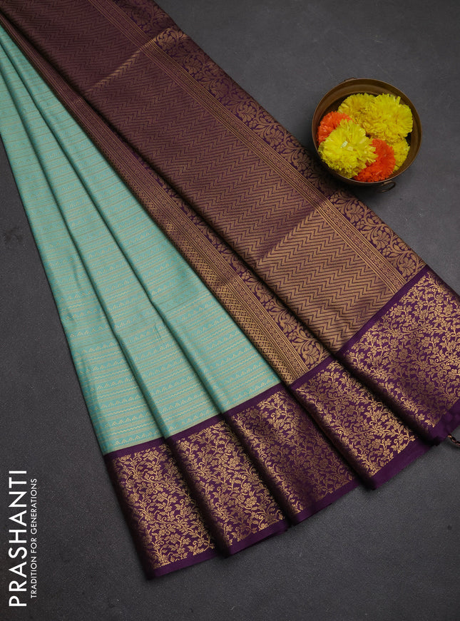 Semi soft silk saree teal green and purple with allover zari brocade weaves and zari woven border