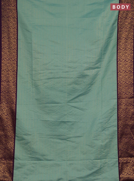Semi soft silk saree teal green and purple with allover zari brocade weaves and zari woven border