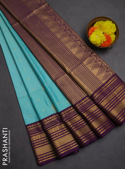 Semi soft silk saree teal shade and purple with allover zari woven buttas and zari woven border