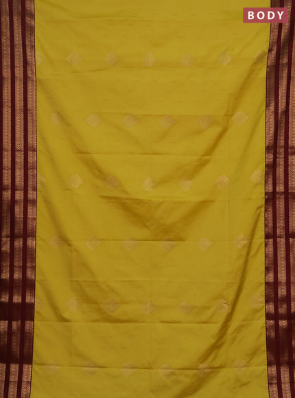 Semi soft silk saree yellow shade and maroon with allover zari woven buttas and zari woven border