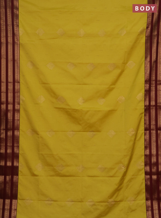 Semi soft silk saree yellow shade and maroon with allover zari woven buttas and zari woven border