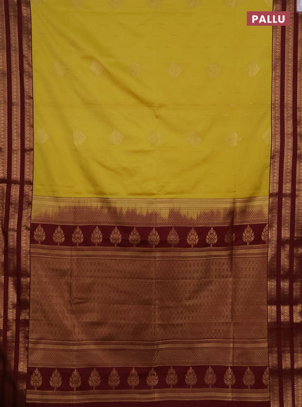 Semi soft silk saree yellow shade and maroon with allover zari woven buttas and zari woven border