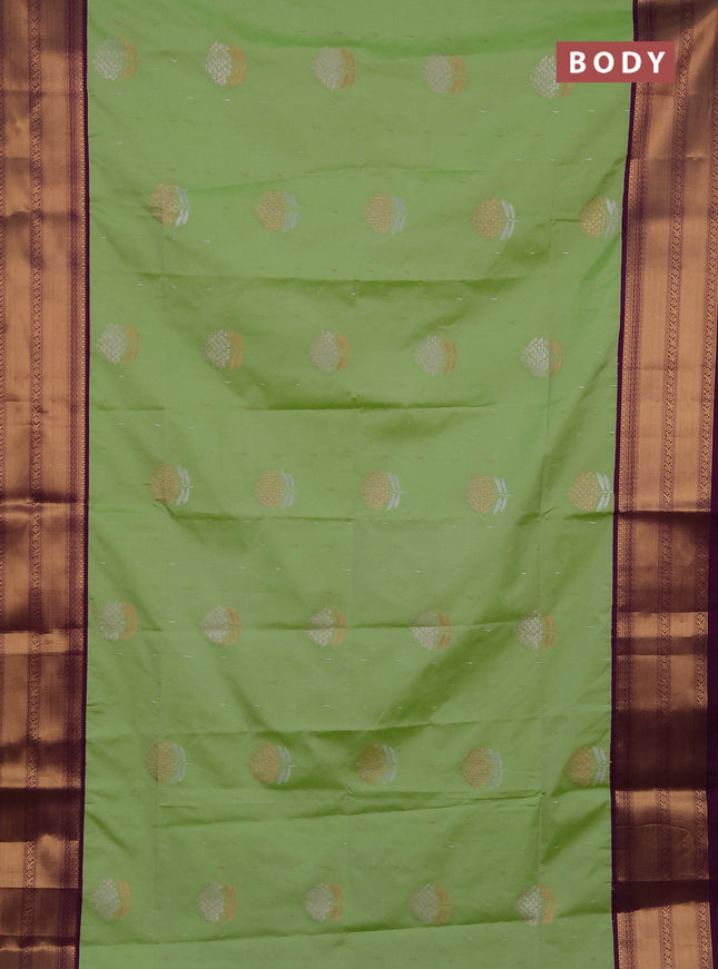 Semi soft silk saree light green and purple with allover silver & gold zari woven buttas and zari woven border