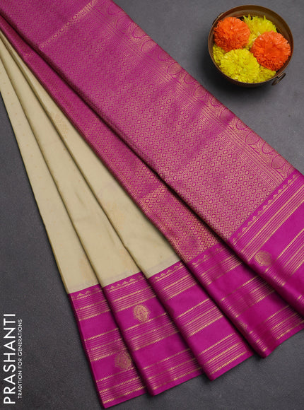 Semi soft silk saree beige and magenta pink with allover zari woven buttas and rettapet zai woven butta border