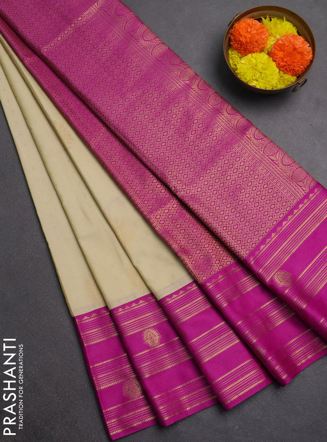 Semi soft silk saree beige and magenta pink with allover zari woven buttas and rettapet zai woven butta border