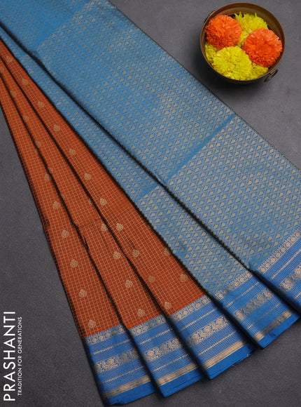 Semi soft silk saree rust shade and cs blue with allover zari checks & buttas and zari woven border