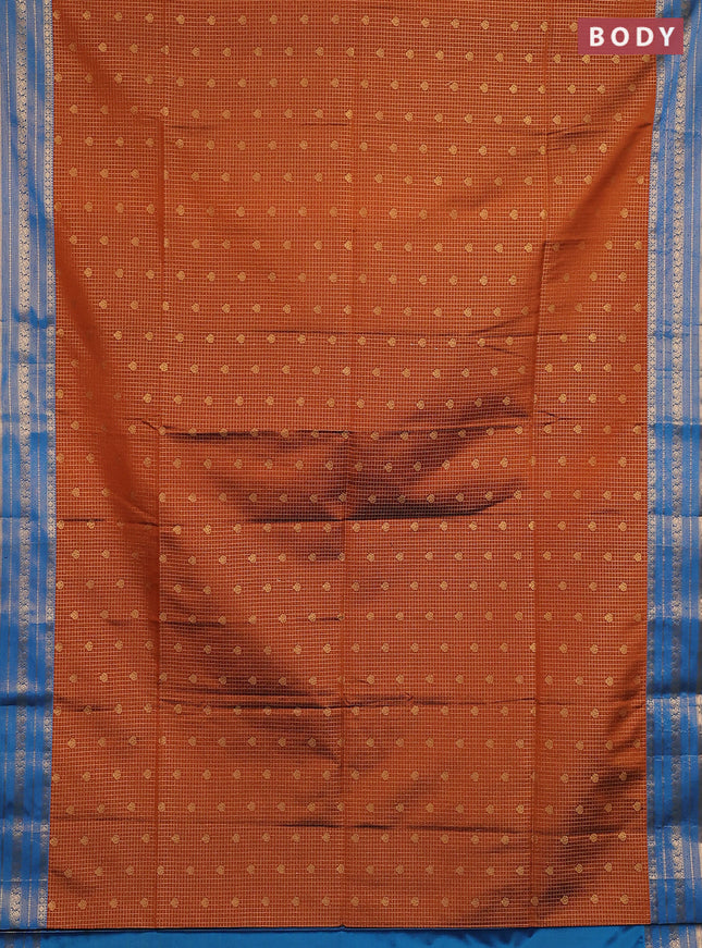 Semi soft silk saree rust shade and cs blue with allover zari checks & buttas and zari woven border