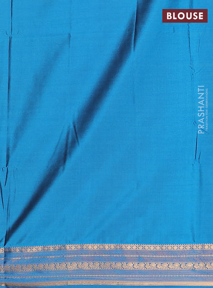 Semi soft silk saree rust shade and cs blue with allover zari checks & buttas and zari woven border