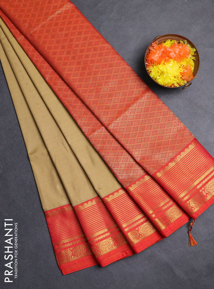 Semi soft silk saree elachi green and orange with allover zari woven buttas and zari woven border