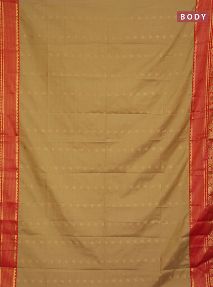 Semi soft silk saree elachi green and orange with allover zari woven buttas and zari woven border