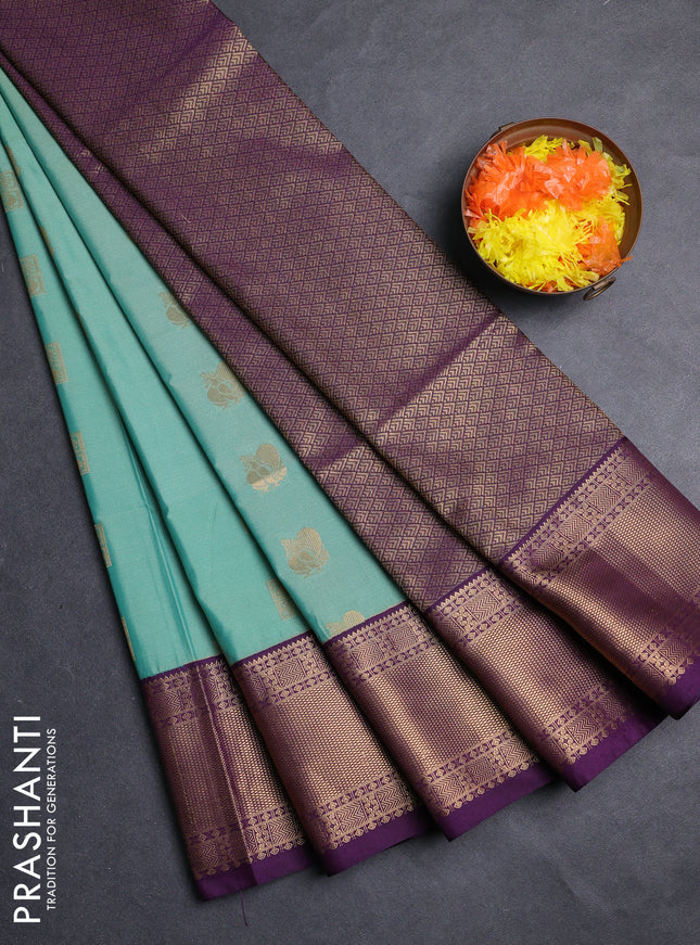 Semi soft silk saree teal green shade and purple with allover zari woven buttas and zari woven border