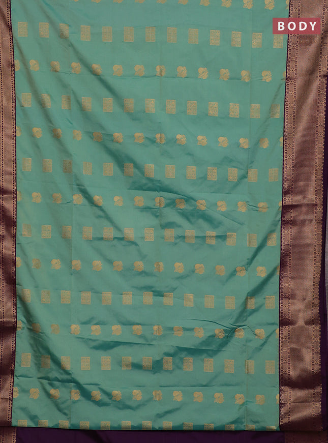 Semi soft silk saree teal green shade and purple with allover zari woven buttas and zari woven border