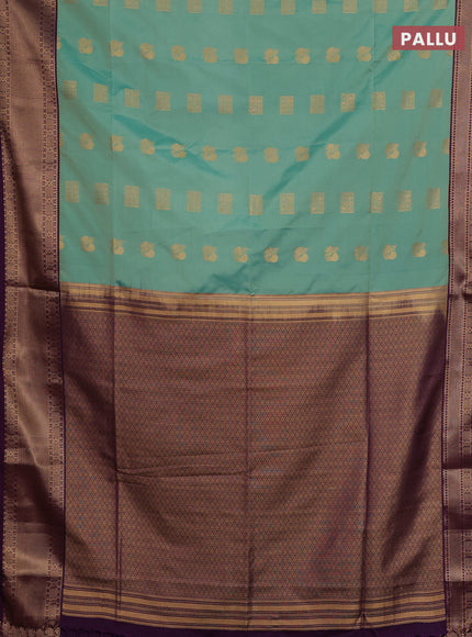 Semi soft silk saree teal green shade and purple with allover zari woven buttas and zari woven border