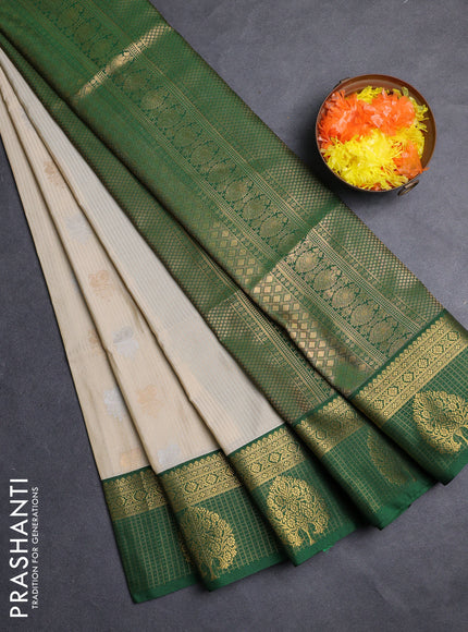 Semi soft silk saree cream and green with allover zari weaves & buttas and zari woven border