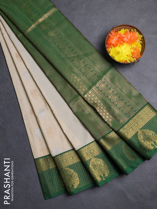 Semi soft silk saree cream and green with allover zari weaves & buttas and zari woven border