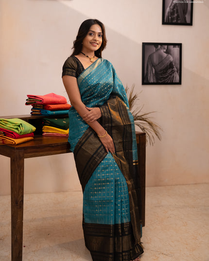 Semi dupion saree teal blue shade and black with allover zari checks & 1000 buttas and long temple zari woven border