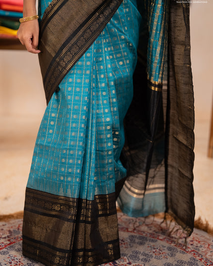 Semi dupion saree teal blue shade and black with allover zari checks & 1000 buttas and long temple zari woven border