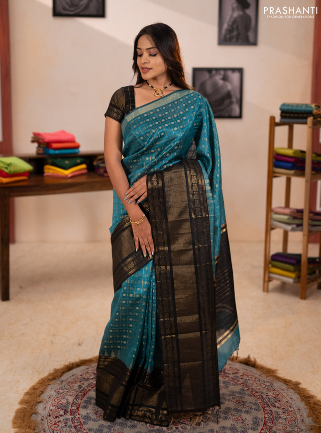 Semi dupion saree teal blue shade and black with allover zari checks & 1000 buttas and long temple zari woven border