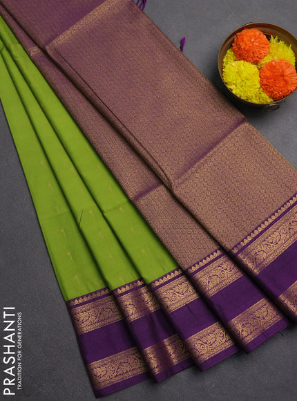 Semi soft silk saree green and purple with allover zari woven buttas and rettapet zari woven border