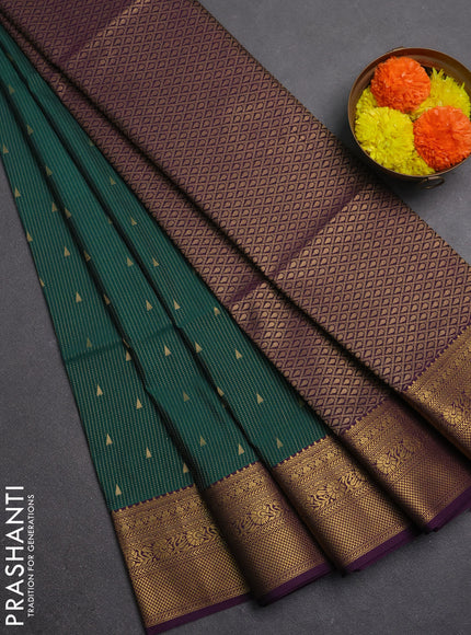 Semi soft silk saree bottle green and purple with allover zari weaves & buttas and zari woven border