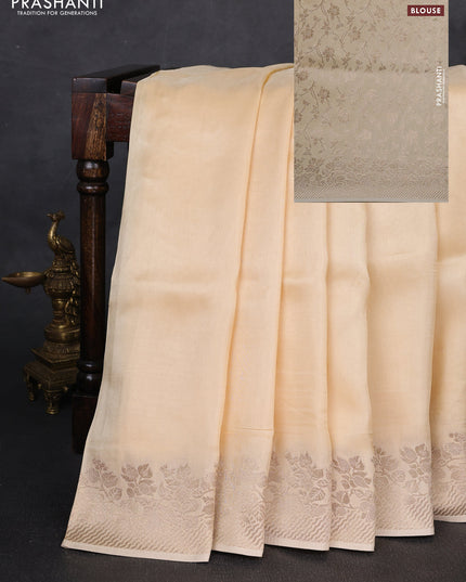 Dola silk saree cream with plain body and zari woven border