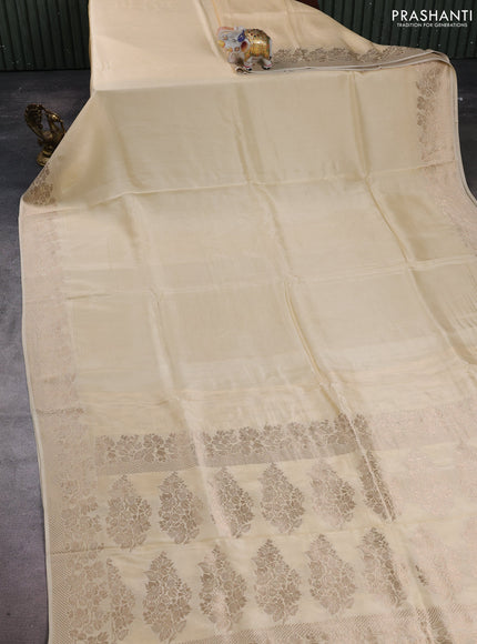 Dola silk saree cream with plain body and zari woven border