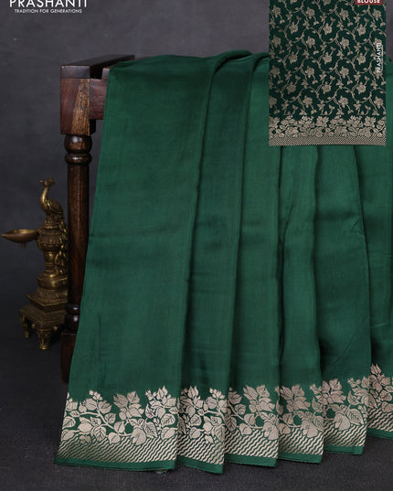 Dola silk saree bottle green with plain body and zari woven border