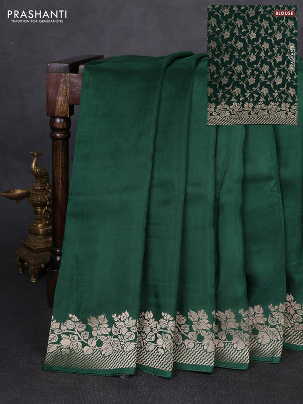 Dola silk saree bottle green with plain body and zari woven border