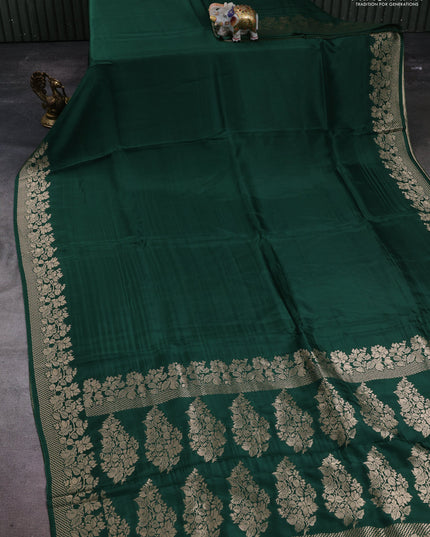 Dola silk saree bottle green with plain body and zari woven border