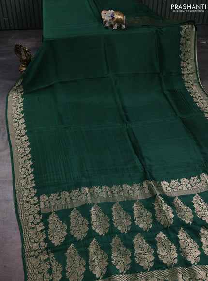 Dola silk saree bottle green with plain body and zari woven border