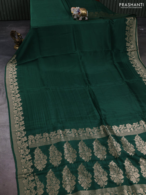 Dola silk saree bottle green with plain body and zari woven border