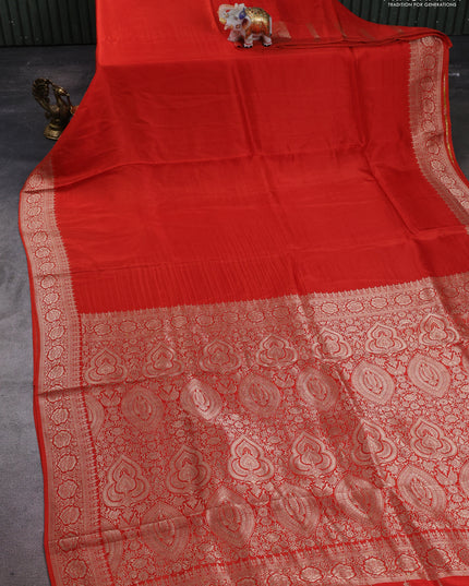 Dola silk saree rust shade with plain body and zari woven border