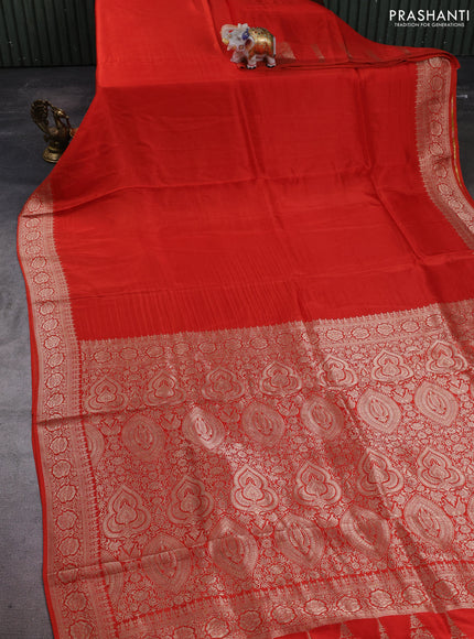 Dola silk saree rust shade with plain body and zari woven border