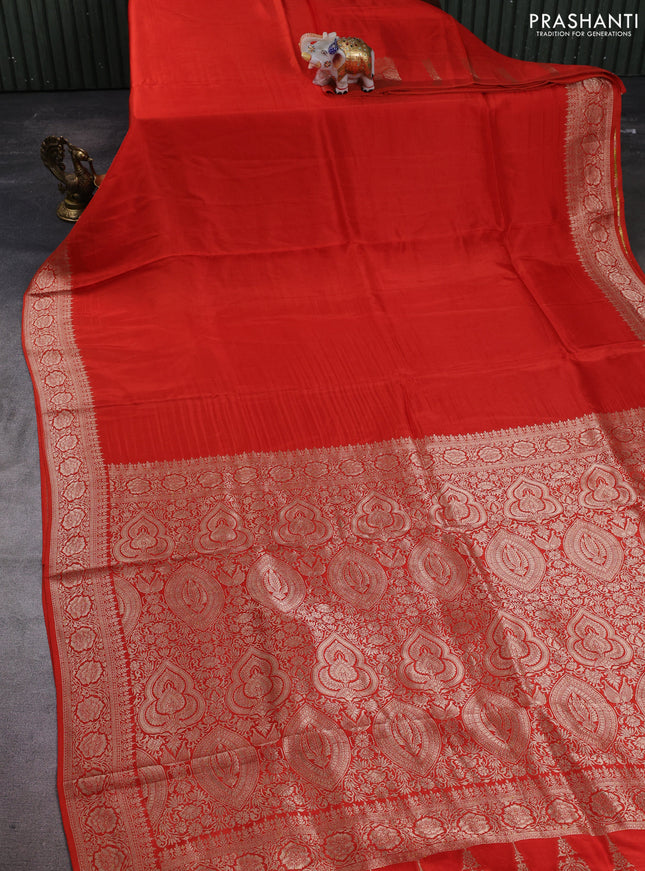 Dola silk saree rust shade with plain body and zari woven border