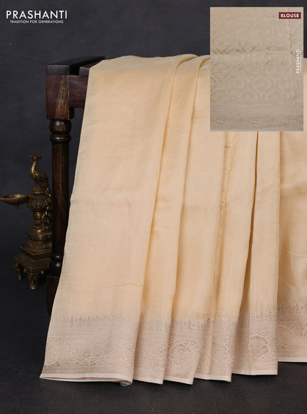 Dola silk saree cream with plain body and zari woven border