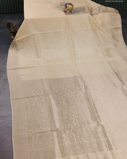 Dola silk saree cream with plain body and zari woven border