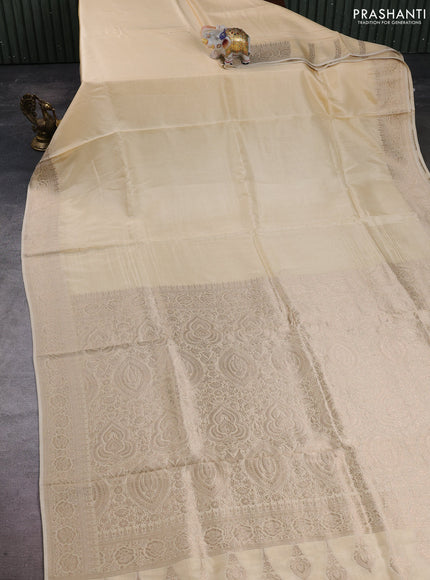 Dola silk saree cream with plain body and zari woven border