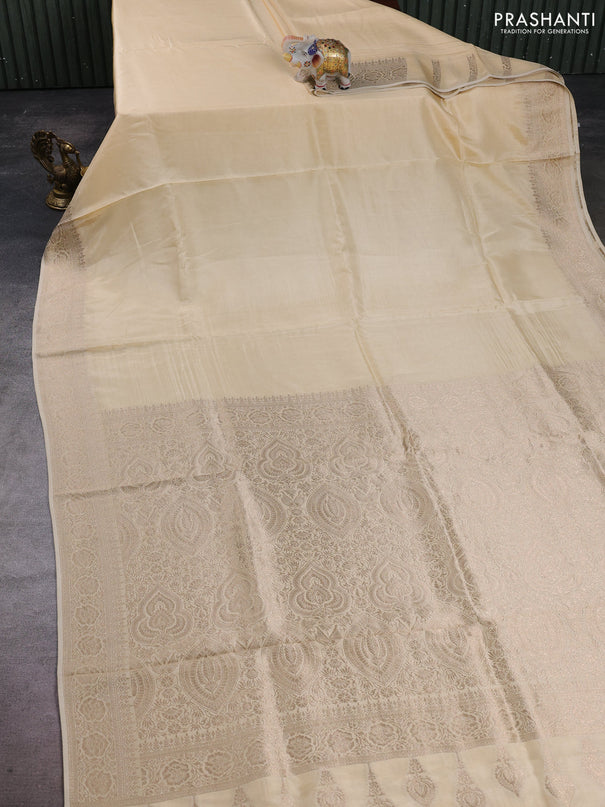 Dola silk saree cream with plain body and zari woven border